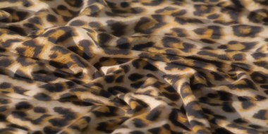 Altın sarısı ve siyah leopar benzeri lekeleri pürüzsüz bir yüzey boyunca akan soyut bir kumaşın bulanıklığı. Organik desen kıvrımlarla çelişiyor, dinamik doku ve derinlik yaratıyor..