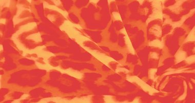 Parlak turuncu ve sarı bir kumaşın bulanık görüntüsü. Leopar desenine benzeyen koyu ve ateşli desenleri var. Yumuşak perdeler ve kıvrımlar derinlik yaratır, kumaşın dinamik görünmesini sağlar