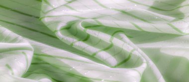 Hassas dikey ve yatay çizgilere sahip açık yeşil kumaş tabakaları. Kumaşın yumuşak bir dokusu ve hafif bir parıltısı var. Zarif ve rahatlatıcı bir görsel yaratıyor..