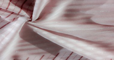 Hassas kırmızı dalgalı ve parlak gümüş aksanlı bulanık pembe kumaş, sakin ve akıcı bir doku yaratıyor. Nazik kıvrımlar ince parlaklığı ve karmaşık deseni vurgular..