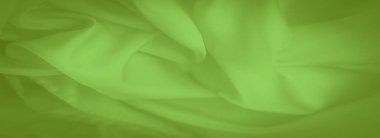 Pürüzsüz ve akışkan dokusu olan parlak yeşil kumaştan oluşan bulanık kıvrımlar, karmaşık kıvrımlar oluşturuyor. Canlı renk ve zarif akış moda veya iç tasarım projelerine doku eklemek için mükemmeldir..