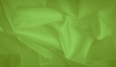 Bulanık, ince kıvrımlı yumuşak yeşil kumaş zarif bir akış dokusu yaratır. Canlı renk ve pürüzsüz yüzey, kumaş odaklı tasarım için mükemmel bir tazelik ve yumuşaklık hissi verir..