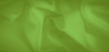 Bulanık yeşil kumaş yumuşak kıvrımlar ve doğal kıvrımlarla pürüzsüzce akar. Parlak dokusu ve yansıtıcı yüzeyi canlı rengini artırarak zarif ve pürüzsüz bir tekstil yaratıyor..