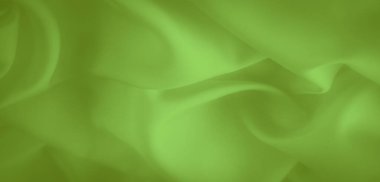 Yumuşak kıvrımlı, pürüzsüz, parlak yeşil kumaştan oluşan bulanık katmanlar yumuşak bir doku oluşturur. Canlı renk ve ince gölgeleme kumaşların akış görünümüne derinlik ekler.