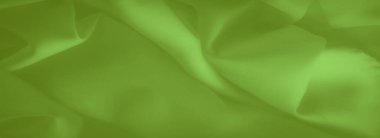 Pürüzsüz, parlak yeşil kumaş, sıvı kıvrımları parlak ve yumuşak bir yüzey sunuyor. Parlak renk ve yumuşak kıvrımlar taze, canlı ve dingin bir kumaş dokusu yaratır..