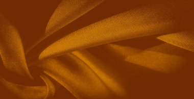 Yumuşak turuncu kumaş bulanıklığı nazikçe katlanıp üst üste biniyor, pürüzsüz bir doku ve ince dokuma sergiliyor. Zengin tonlar, zarafet ve akış duygusu ile sıcak, davetkar bir atmosfer yaratır..