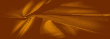 Pürüzsüz dokular ve yumuşak ışıklandırmayla birlikte sarı kumaş kıvrımlarının bulanık görüntüsü, sıcak tonlarda kumaş kırışıklıklarının soyut ama ayrıntılı bir görüntüsünü oluşturuyor. Tekstil, tasarım veya moda temaları için mükemmel