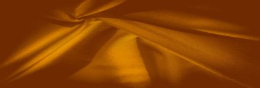 Karmaşık kıvrımlı sarı kumaşlı bulanık doku ve zengin, canlı renkler. Kumaşın akış katları çarpıcı bir doku ve derinlik dengesi sunuyor, yaratıcı tekstil tasarımı için mükemmel..