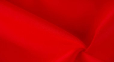 Bulanık, koyu kırmızı kumaş zarif bir şekilde yumuşak kıvrımlarla örtülmüş, zengin ve ipeksi bir doku sergiliyor. Kalın kırmızı renk onun lüks görünümünü arttırır, onu arka plan ve moda tasarımları için ideal kılar.