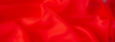 Pürüzsüz, parlak kırmızı kumaşlı, yumuşak kıvrımlarla sarılı. Parlak kırmızı renk ve lüks dokular göz alıcı, dinamik bir desen oluşturur..