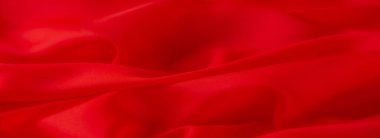 Canlı kırmızı kumaş bulanıklığı zarif bir şekilde pürüzsüz katmanlara katlanmış. Parlak dokusu ve zengin tonu kumaşların yumuşaklığını ve zarafetini vurgular. Lüks tekstil tasarımı için mükemmeldir..