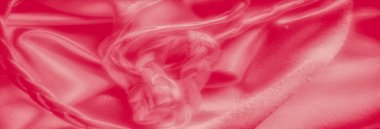 Pürüzsüz, akıcı kıvrımları olan canlı pembe bir kumaş hassas ve zarif bir doku yaratır. Malzemenin yumuşak parıltısı lüks görünümünü arttırıyor, akıcılık ve sıcaklık hissi uyandırıyor..