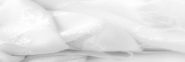 Karmaşık bir çiçek desenli bulanık beyaz kumaş. Tasarım doku ve boyut ekler, zarif ve rafine bir görünüm yaratır. Lüks iç dekorasyon için ideal.