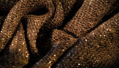 Karmaşık desenli ve parıltılı kumaşlı koyu altından parlak bir görünüm yumuşak kıvrımları ve zengin yüzey detaylarını yakalamak lüks kumaş arkaplanları için idealdir.