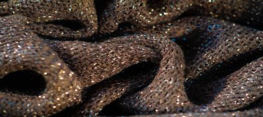 Parlak röfleli koyu renk kumaş bulanıklığı, hafif bir parıltı etkisi. Doku yumuşak ama yapılandırılmış görünüyor, küçük ışık zerreleri maddeye boyut ve derinlik katıyor..