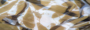 Beyaz desenli yumuşak kahverengi kumaş bulanıklığı. Saf, hafif doku modern ve soyut bir estetik tasarım sağlar, çeşitli moda ve dekor uygulamaları için uygundur..