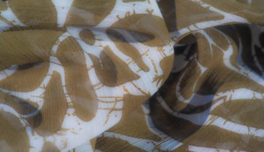 Beyaz desenli yumuşak kahverengi kumaş bulanıklığı. Saf, hafif doku modern ve soyut bir estetik tasarım sağlar, çeşitli moda ve dekor uygulamaları için uygundur..