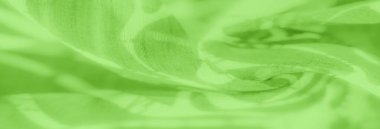 Açık yeşil kumaştan bulanık, beyaz ve koyu yeşil tonlarda yumuşak soyut desenler içeren ince kıvrımlar zarif ve minimalist tasarımlar için mükemmel bir akış efekti yaratır.