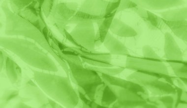 Soyut beyaz desenli bulanık yeşil kumaş yumuşak dalgalar yaratıyor. Kumaş hafif ve şeffaf görünüyor, yumuşak kıvrımlar ve kıvrımlar halinde akıyor, tasarımın organik hissini arttırıyor..