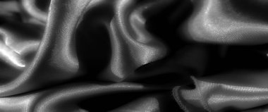 Yumuşak kıvrımlar halinde kıvrılan parlak kumaşların siyah bulanıklığı, ışığı karmaşık yollarla yansıtıyor. Lüks dokusu zarif, zarif bir estetik sunuyor. Moda ve tasarım unsurları için mükemmel..