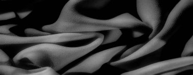 Gri tonlu kumaş yumuşak kıvrımlı ve hassas yapıda pürüzsüz malzeme akışı ve gölgelerin etkileşimi görüntüye zarif ve sakin bir iç dekorasyon ya da moda için mükemmel bir cazibe veriyor.