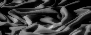 Görüntü, gri kumaşın karmaşık kıvrımlarını yakalar. Gölgeler derinlik ve boyut ekler. Yumuşak dokular, sakin ve minimalist bir soyut tasarım yaratır..