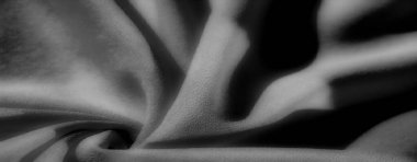 Siyah, Görüntü, bu gri ölçekli kumaş çekimi dinamik kıvrımlar ve yumuşak dokular içerir. Yüzeyde derin gölgeler oluşur ve büyüleyici, soyut bir görsel görüntü yaratır..