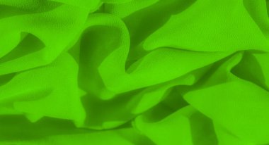 Neon yeşil kumaş bulanıklığı kıvrımların dinamik bir bileşimini sunar yumuşak dokular ve tanımlanmış gölgeler. Yumuşak kıvrımlar ve katmanlı yapı kumaşta derinlik ve hareket yaratır.