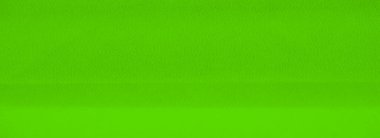 Parlak yeşil kumaş perdeleri yumuşak, akışkan kıvrımlar halinde, karmaşık dokular oluşturur ve gölgelendirir. Pürüzsüz malzeme, kumaşın tasarımının soyut doğasını geliştirir..