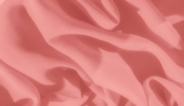 Pembe desenli bulanık kumaş, narin kıvrımlı ve gölgeli bir efekt yaratır. Arka plan, moda ya da tasarım unsurları için idealdir..