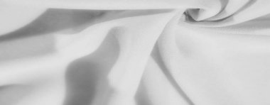 Yumuşak kıvrımlar ve akışkan çizgilerle kaplanmış bulanık, yumuşak gri tonlu kumaş desenli kumaş boyunca pürüzsüz gölgeler bırakıyor. Hassas desenler minimalist, çağdaş bir estetik yaratıyor..