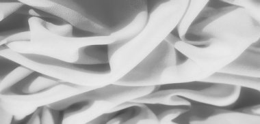 Bulanık, dalgalı gri renkli kumaş yumuşak dalgalar ve karmaşık kıvrımlar. Dokulu yüzeydeki ışık ve gölgeler bir hareket, sakinlik ve minimalist güzellik hissi yaratıyor..