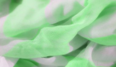 Açık yeşil ve beyaz kumaşlı bulanık yumuşak dalgalarla sarmalanmış. Pürüzsüz dokusu ve canlı renkleri modern, pürüzsüz bir desen sağlıyor. Tekstil ve moda tasarımı için mükemmel..