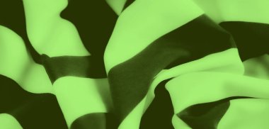 Pürüzsüz kıvrımları ve koyu siyah çizgileri olan parlak yeşil bir kumaşın bulanıklığı, yüzey boyunca canlı, soyut bir akış yaratır yumuşak doku ve katmanlı katmanlar dinamik bir gölge ve ışık oyunu sunar.