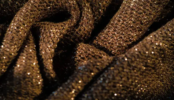 Karmaşık desenli ve parıltılı kumaşlı koyu altından parlak bir görünüm yumuşak kıvrımları ve zengin yüzey detaylarını yakalamak lüks kumaş arkaplanları için idealdir.