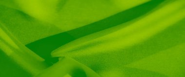 Belirgin kıvrımları olan canlı yeşil kumaştan oluşan bulanık, karmaşık bir doku ve hareket hissi veren, soyut arka planlar için mükemmel dijital ya da baskı tasarımı.