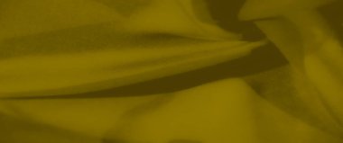 Yumuşak, akışkan kıvrımlı hardal sarısı bir kumaşın bulanıklığı. Zengin renk ve doğal kumaş çeşitli tasarım ihtiyaçları için uygun rahat ve şık bir ortam yaratır..