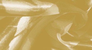 Nazikçe akan kıvrımlı bulanık sarı kumaş, narin bir parıltıda ışığı yakalıyor. Yumuşak dokusu ve sıcak tonu lüks ve sofistike bir görüntü yayar..
