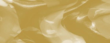 Yumuşak sarı kumaştan bulanık, narin kıvrımlı, yumuşak, yumuşak bir dokuyu ortaya çıkaran ışığı yakalayan, zarafet ve yumuşaklığı çağrıştıran..