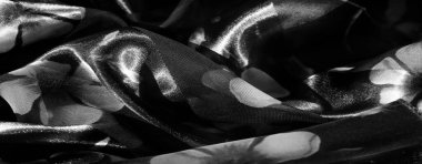 Gri tonda ince çiçek izleri içeren çizgili kumaş bulanıklığı. Narin taç yaprakları zarif ve minimalist tasarımlar için ideal yumuşak, uyumlu bir görünüm yaratır..