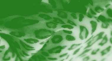 Görüntü bu yeşil tekstil soyut desenler doğal dokuları çağrıştırıyor. Yumuşak, pürüzsüz kumaş, canlı renk ve organik şekillerin eşsiz bir karışımını sunar..