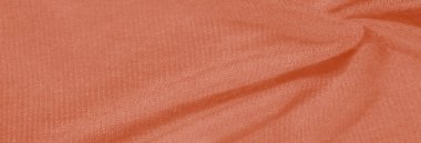 Görüntü - Yumuşak, desenli ve katlanmış turuncu kumaş narin röfleler sergiliyor, dokulu arka planlar ve yaratıcı tekstil tasarım projeleri için ideal hale getiriyor.