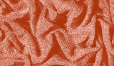 Görüntü. Yumuşak kıvrımlı turuncu kumaş ve parlak bir parıltı. Karmaşık katman zarif bir zemin oluşturuyor, moda veya tasarıma odaklı kullanım için ideal..