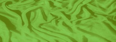 Karmaşık kıvrımlı parlak yeşil kumaştan oluşan bulanık bir görünüm yaratıyor. Lüks malzeme ve zengin renk yaratıcı tasarım geçmişi ve tekstil uygulamaları için mükemmeldir..