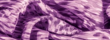 Kıvrımlı, mor renkli, kıvrımlı bir kumaşın bulanıklığı. Katlar yumuşak gölgeler ve röfle oluşturarak kompozisyona derinlik ve akıcılık hissi katıyor..