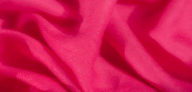 Yumuşak, pürüzsüz bir dokusu ve derinlik yaratan doğal kıvrımları olan canlı pembe kumaş bulanıklığı. Zengin renkler ve dalgalı kumaşlar lüks hissi katar, moda ve tekstil görselleri için mükemmeldir.