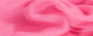 Yumuşak, akıcı bir dokusu olan canlı pembe kumaş bulanıklığı, nazikçe katlanmış, dalga benzeri bir desen yaratıyor. Kumaşın yakın çekimi ince bir tahıl ve hassas bir yüzeyi ortaya çıkarıyor..