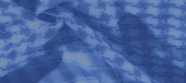 Bulanık desenli mavi kumaş dokunmuş ince dokunmuş desenler ve dokunmuş detaylar. Karmaşık kıvrımlar, tekstil boyunca yumuşak gölge oyunu ve derinlik yaratır..