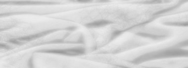 Hassas kıvrımları ve yumuşak gölgeleri olan bulanık beyaz kumaş dokusu zarif ve ruhani bir görünüm yaratıyor. Konforlu ve hafif görünüyor.