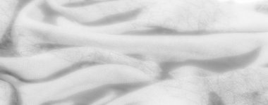 Yumuşak beyaz kumaştaki bulanık dokular ince ayrıntılar ve doğal akışlar gösterir, ışık yüzeyini hafifçe vurgular, minimalist temalar için mükemmel bir arka plan sunar..